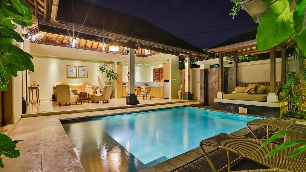 Luxurious Sotogrande villa with a private pool and open-concept living space at night.