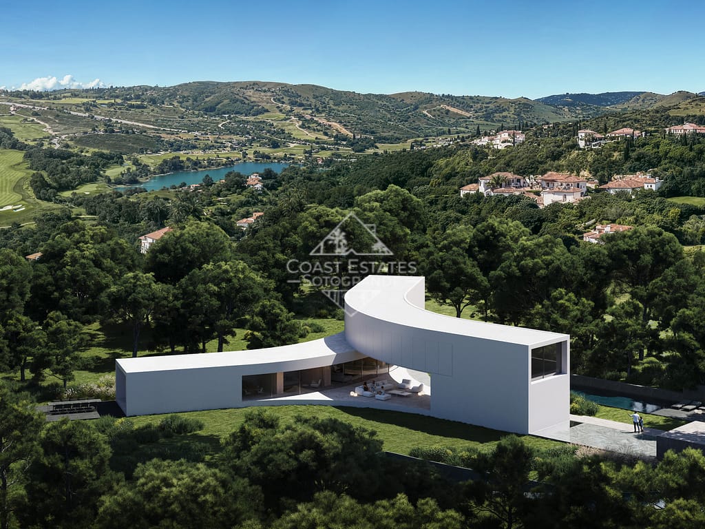 Ultra-modern luxury villa in Sotogrande with a unique curved design, surrounded by lush greenery and panoramic golf course views.